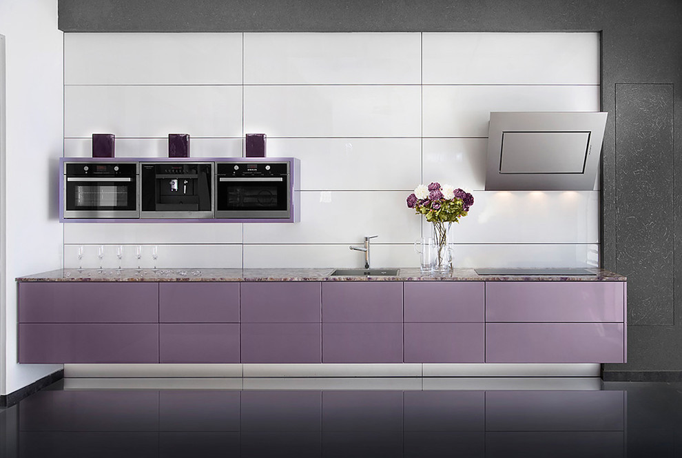 Example of a minimalist kitchen design in Other with flat-panel cabinets and white backsplash