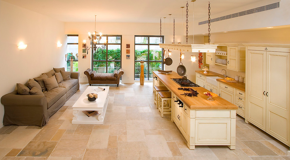 Cottage galley open concept kitchen photo in Other with a farmhouse sink, wood countertops and recessed-panel cabinets