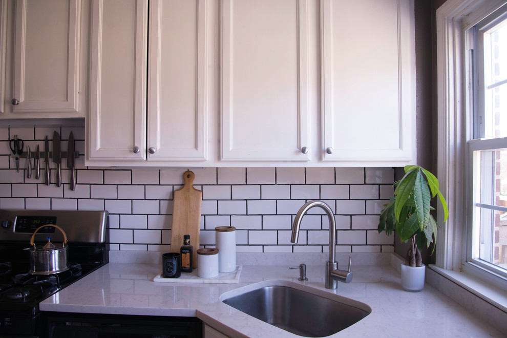 Example of a transitional kitchen design in Baltimore with a drop-in sink, recessed-panel cabinets, white cabinets, white backsplash, subway tile backsplash and stainless steel appliances