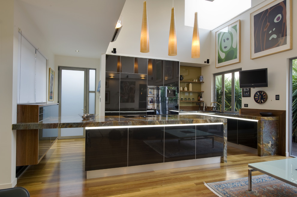 Design ideas for a modern kitchen in Brisbane with flat-panel cabinets, black cabinets and integrated appliances.