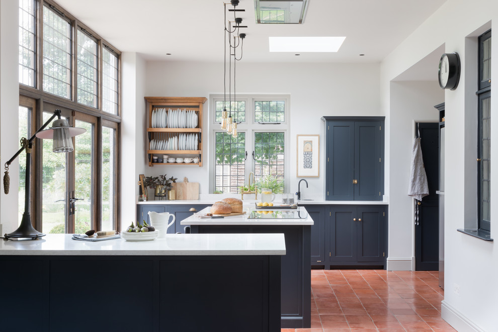 Inspiration for a kitchen in Hertfordshire with a double-bowl sink, shaker cabinets, blue cabinets, an island and white worktops.