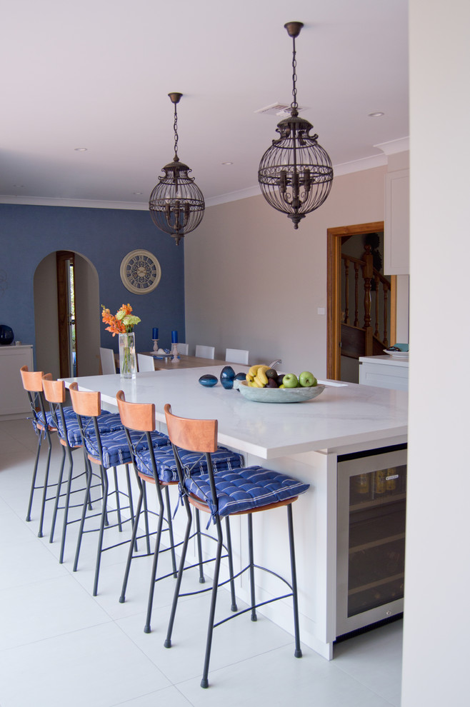 Large contemporary l-shaped open plan kitchen in Canberra - Queanbeyan with a double-bowl sink, recessed-panel cabinets, white cabinets, marble worktops, stainless steel appliances, porcelain flooring and an island.