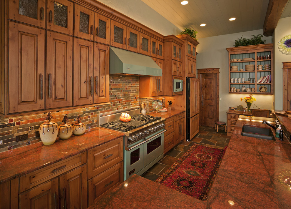 Open concept kitchen - large rustic l-shaped slate floor and multicolored floor open concept kitchen idea in Other with raised-panel cabinets, medium tone wood cabinets, an undermount sink, granite countertops, multicolored backsplash, colored appliances, an island and slate backsplash