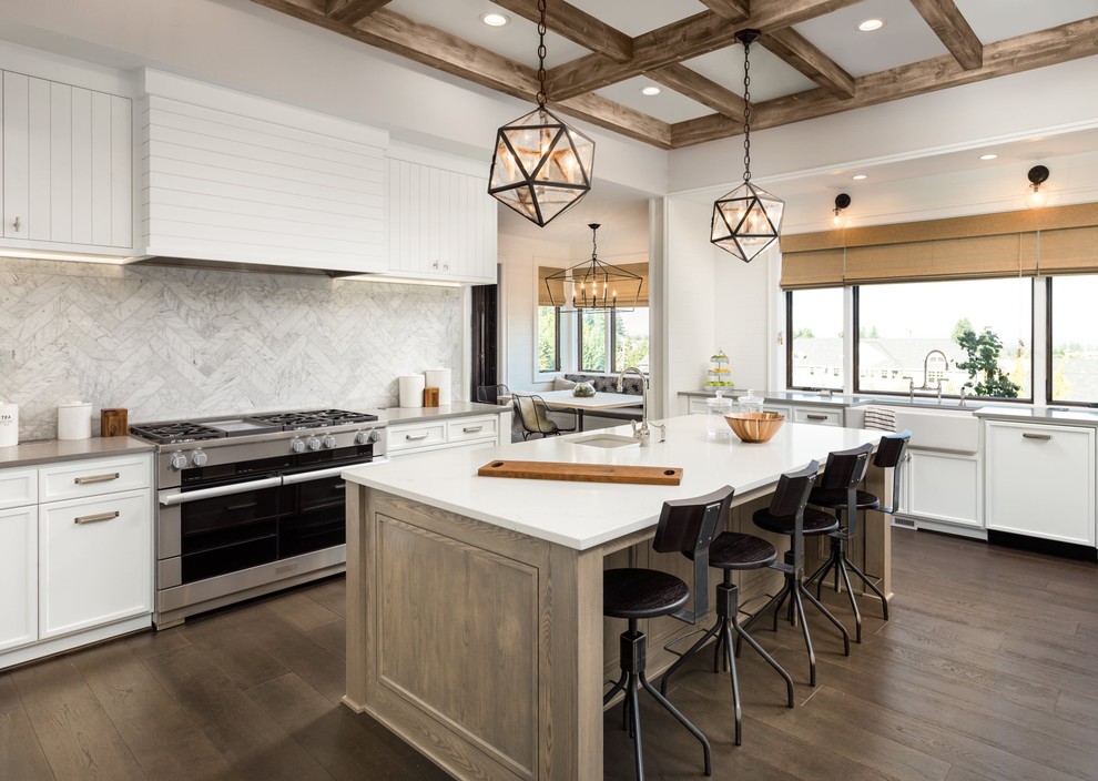 Mid-sized transitional u-shaped dark wood floor and brown floor eat-in kitchen photo in Atlanta with a farmhouse sink, shaker cabinets, white cabinets, quartzite countertops, white backsplash, marble backsplash, stainless steel appliances, an island and white countertops