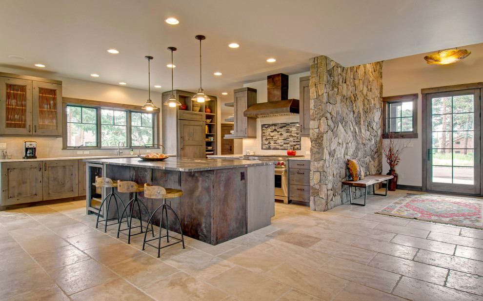 Example of a mountain style l-shaped beige floor kitchen design in Denver with recessed-panel cabinets, dark wood cabinets, stainless steel appliances and an island