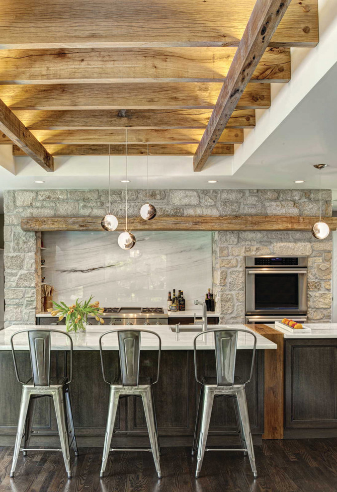 Example of a transitional galley dark wood floor kitchen design in Chicago with recessed-panel cabinets, dark wood cabinets, white backsplash, stainless steel appliances, an island and marble backsplash