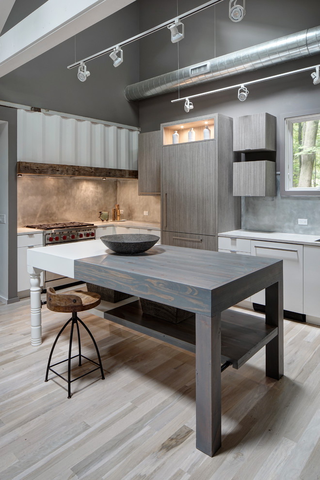 Kitchen - mid-sized contemporary l-shaped light wood floor and beige floor kitchen idea in Chicago with an island, an undermount sink, flat-panel cabinets, white cabinets, solid surface countertops, gray backsplash, stone slab backsplash and stainless steel appliances