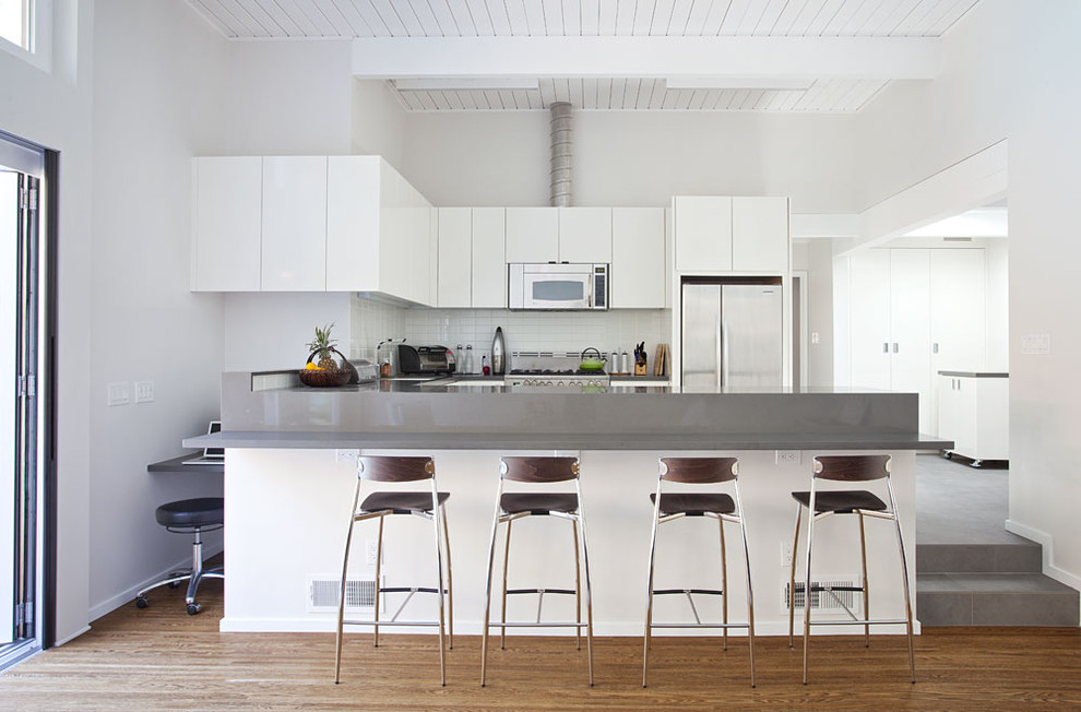 This is an example of a retro kitchen in San Francisco with engineered stone countertops.