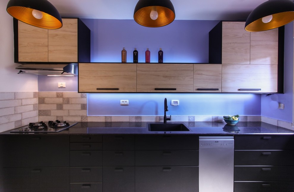 Example of a mid-sized minimalist porcelain tile and beige floor enclosed kitchen design in Tel Aviv with a single-bowl sink, black cabinets, marble countertops, blue backsplash, stone tile backsplash, stainless steel appliances and no island