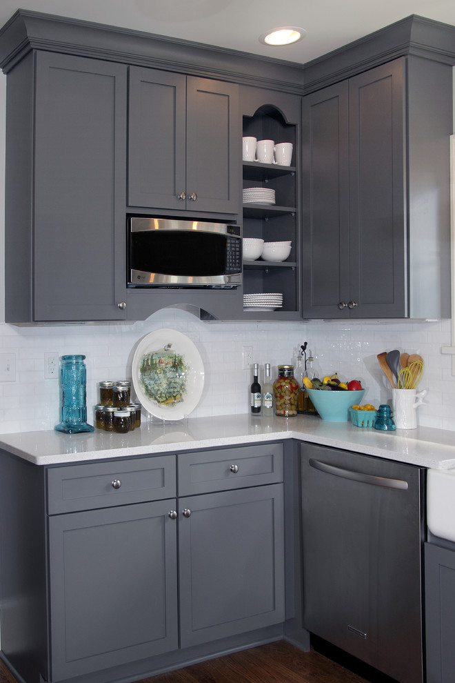 Inspiration for a mid-sized transitional u-shaped dark wood floor and brown floor eat-in kitchen remodel in Milwaukee with a farmhouse sink, shaker cabinets, gray cabinets, white backsplash, subway tile backsplash, stainless steel appliances, quartzite countertops and white countertops