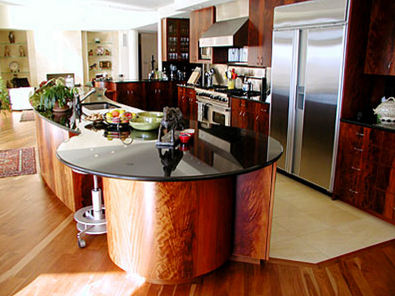 Large contemporary l-shaped kitchen/diner in Boston with flat-panel cabinets, stainless steel appliances, an island, a submerged sink, engineered stone countertops, medium wood cabinets, terracotta flooring and beige floors.