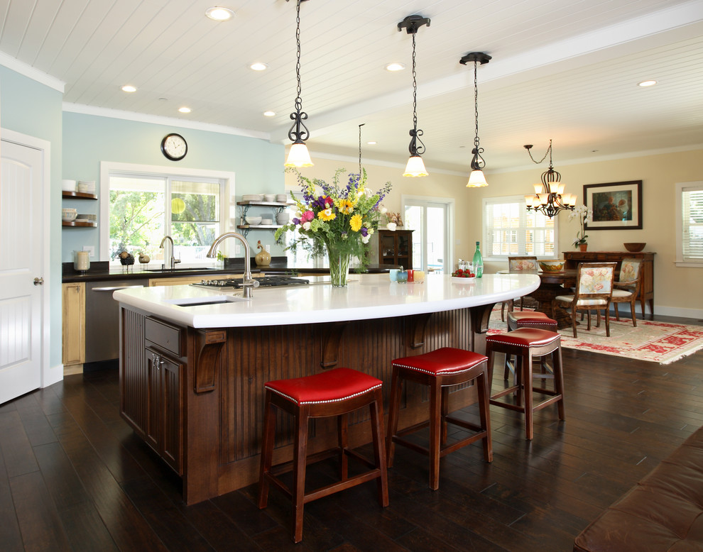 Eat-in kitchen - large farmhouse dark wood floor eat-in kitchen idea in San Francisco with beaded inset cabinets, yellow cabinets, an island, an undermount sink, black backsplash and stainless steel appliances