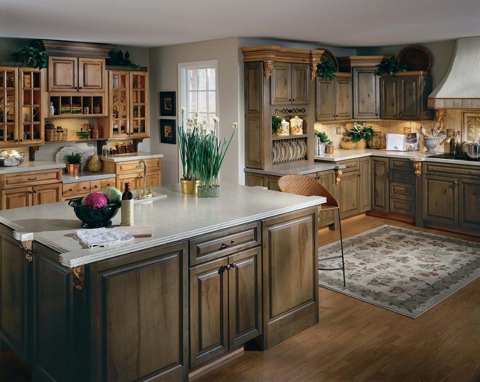 Inspiration for a large french country medium tone wood floor and brown floor kitchen remodel in Phoenix with a drop-in sink, raised-panel cabinets, medium tone wood cabinets, terrazzo countertops, beige backsplash, ceramic backsplash, paneled appliances and an island