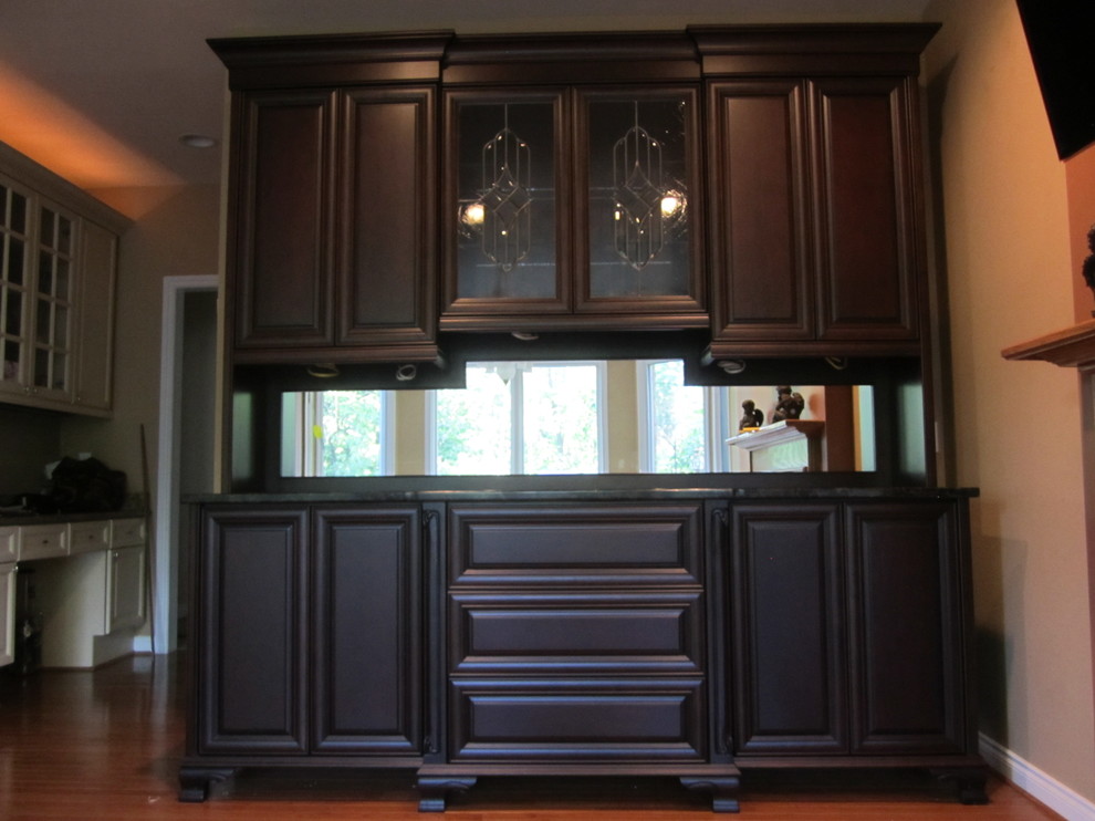 Photo of a medium sized traditional single-wall kitchen/diner in Detroit with glass-front cabinets, brown cabinets and granite worktops.