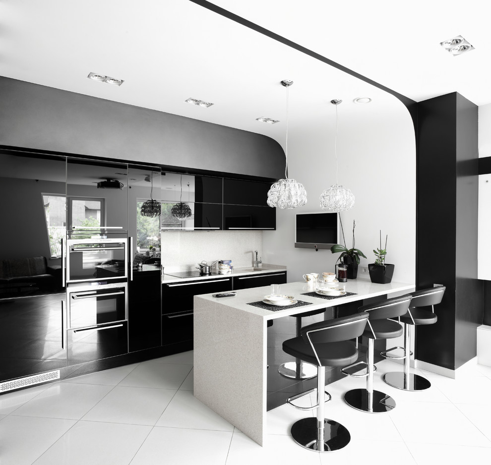 Photo of a medium sized contemporary single-wall kitchen/diner in New York with a built-in sink, medium wood cabinets, granite worktops, white splashback, coloured appliances, medium hardwood flooring and an island.