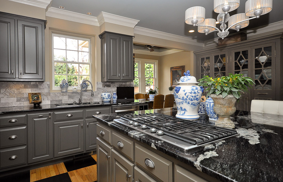 Kitchen - mid-sized traditional l-shaped kitchen idea in Other with an undermount sink, raised-panel cabinets, gray cabinets, gray backsplash, stainless steel appliances and an island