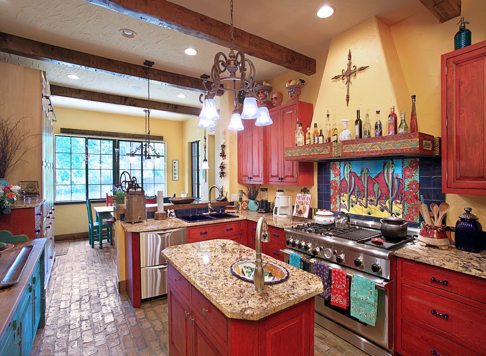 Southwest brick floor kitchen photo in Tampa with stainless steel appliances, a drop-in sink, raised-panel cabinets, multicolored backsplash and medium tone wood cabinets