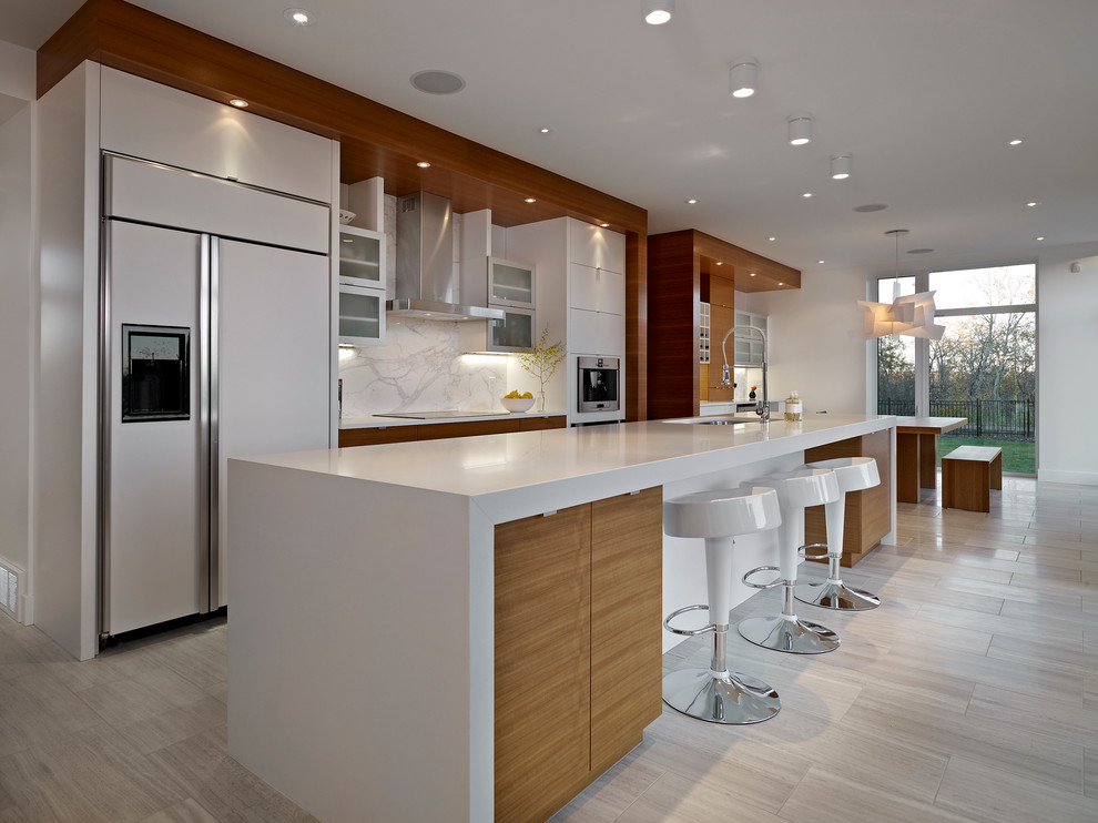 На фото: параллельная кухня в современном стиле с белой техникой, плоскими фасадами, белыми фасадами, белым фартуком, фартуком из каменной плиты, обеденным столом, врезной мойкой и барной стойкой с