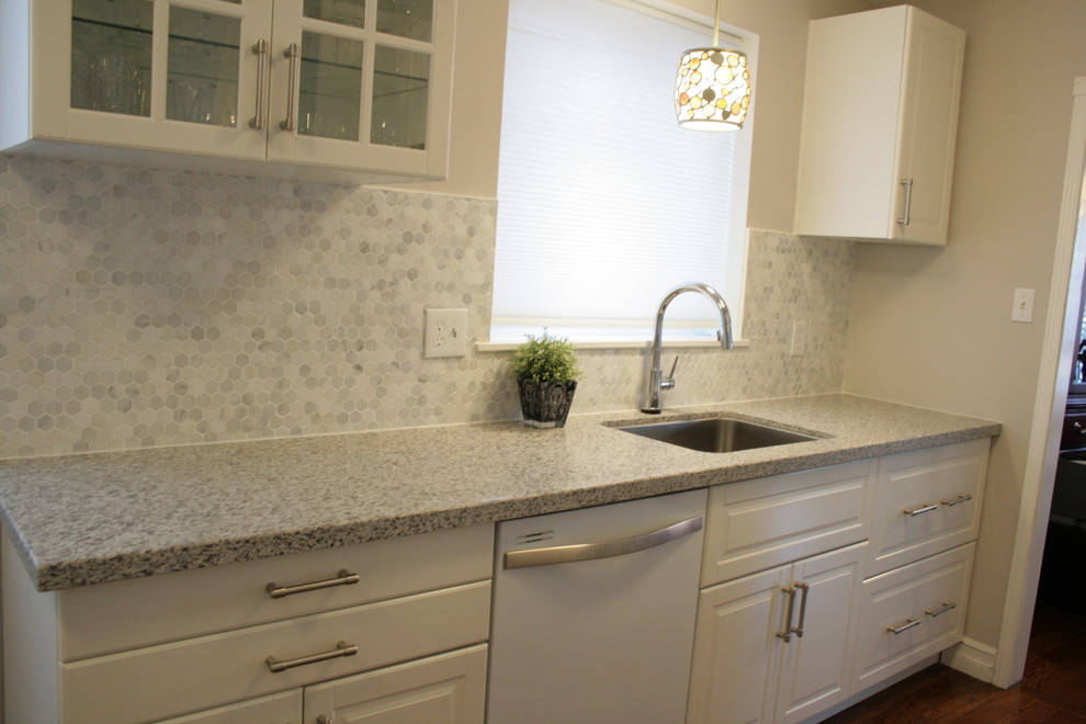 This is an example of a medium sized contemporary galley enclosed kitchen in Toronto with a submerged sink, raised-panel cabinets, white cabinets, engineered stone countertops, grey splashback, mosaic tiled splashback, white appliances, medium hardwood flooring and no island.