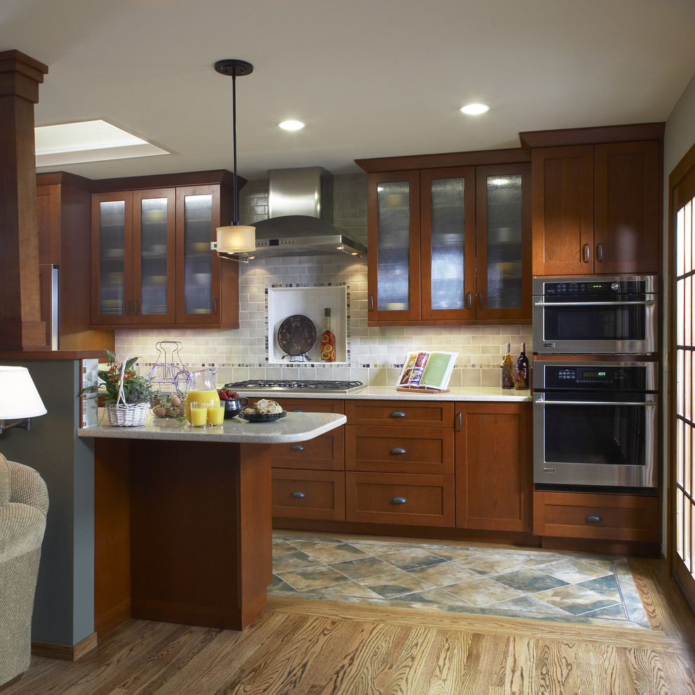 Example of a classic multicolored floor kitchen design in San Francisco with stainless steel appliances, shaker cabinets, dark wood cabinets, gray backsplash and subway tile backsplash