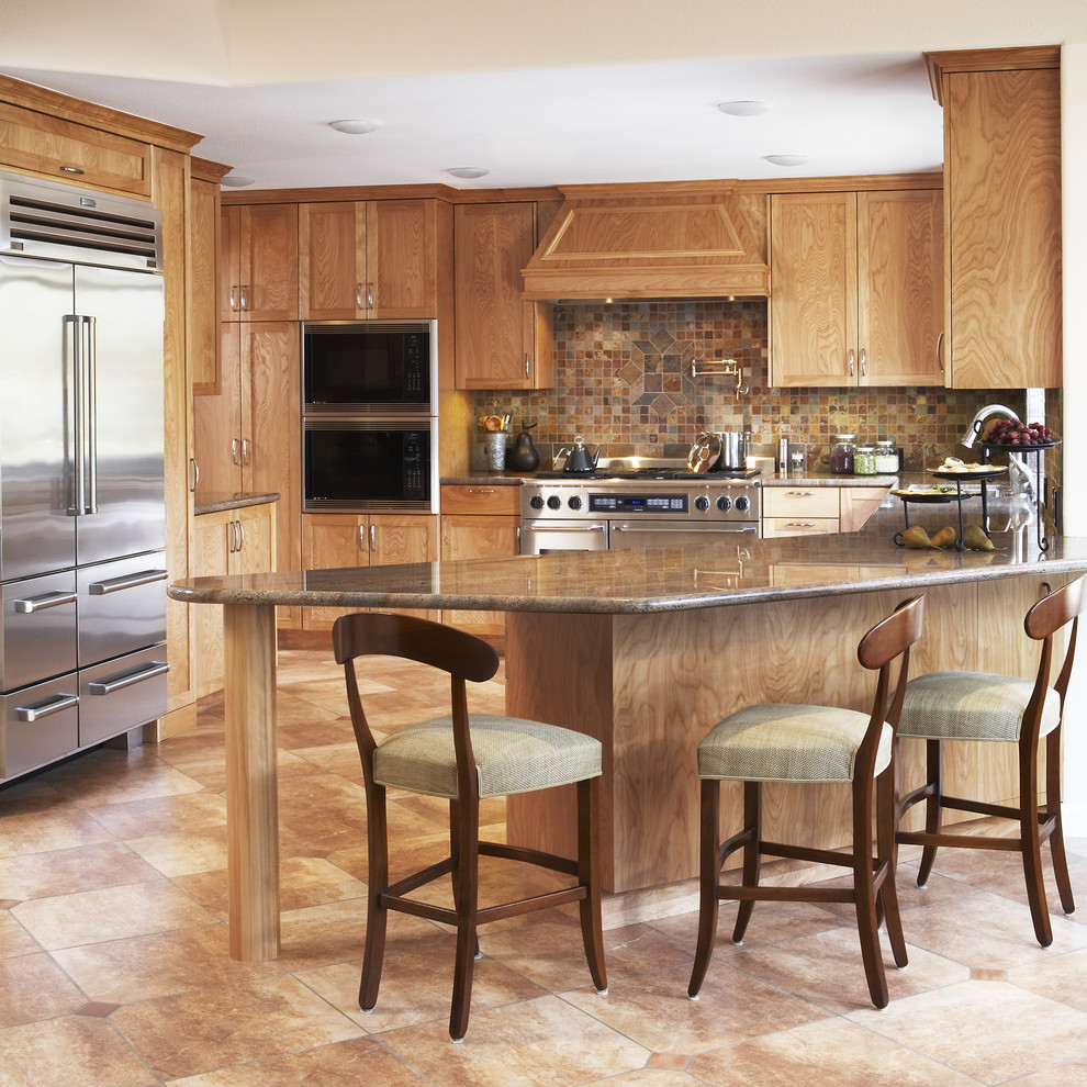 Example of a tuscan u-shaped kitchen design in San Francisco with stainless steel appliances, shaker cabinets, medium tone wood cabinets, brown backsplash and slate backsplash