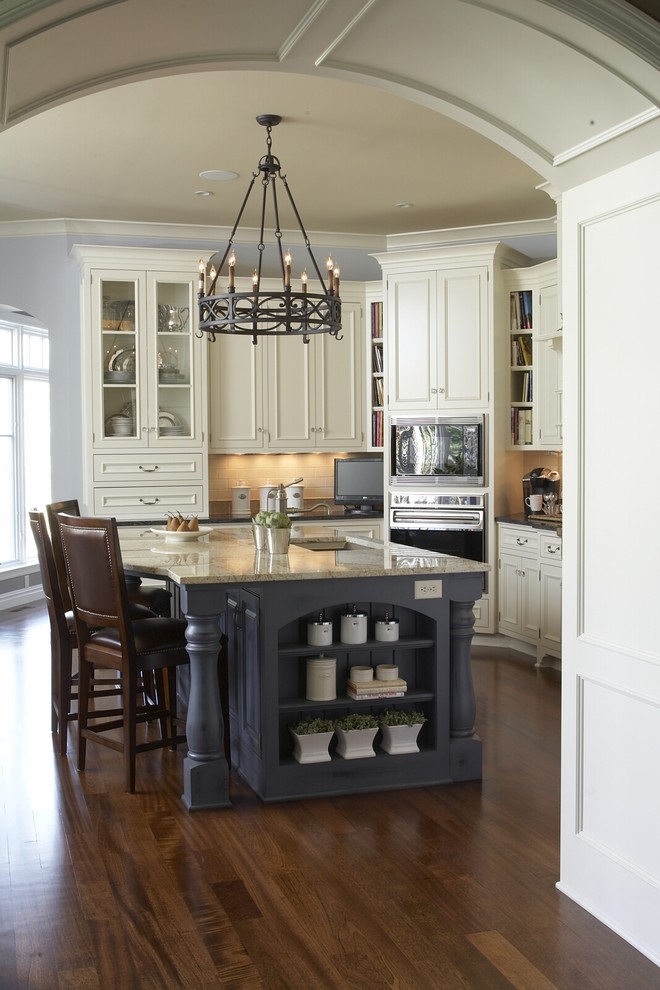 Kitchen - traditional kitchen idea in Minneapolis with recessed-panel cabinets, white cabinets and beige backsplash