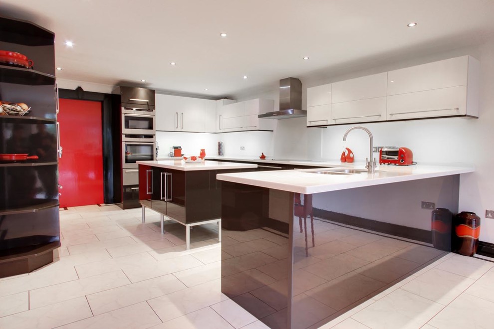 Photo of a large contemporary u-shaped kitchen/diner in London with a double-bowl sink, flat-panel cabinets, brown cabinets, stainless steel appliances, porcelain flooring and an island.