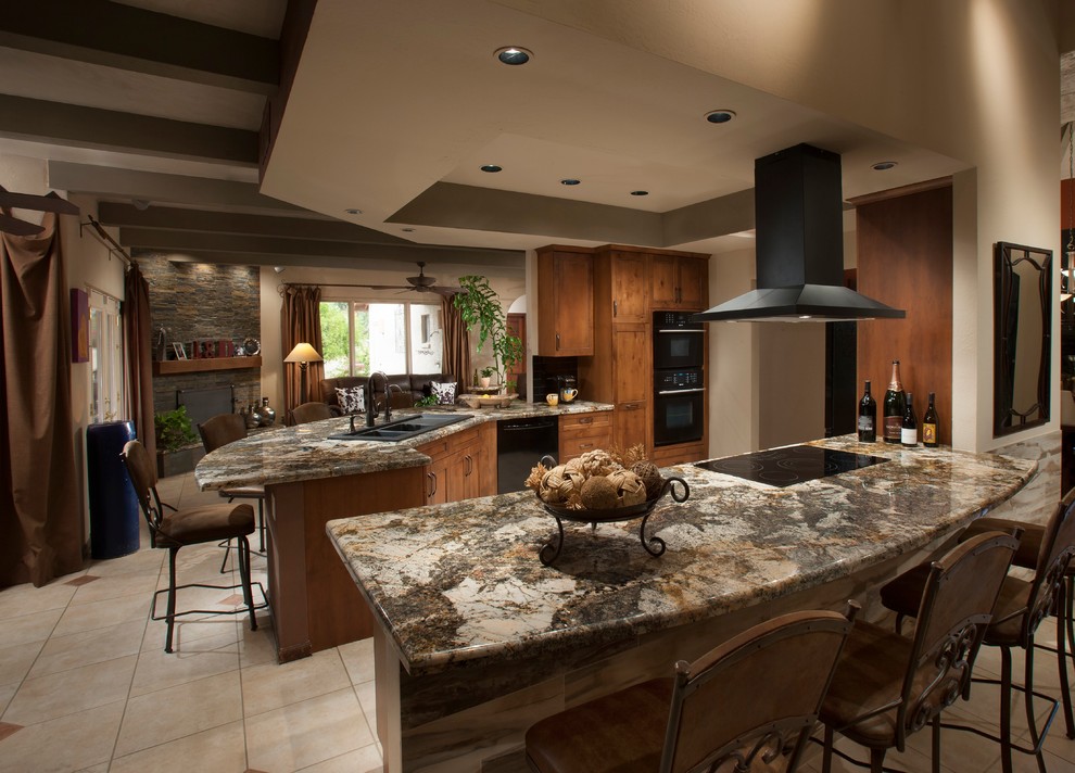 Open concept kitchen - mid-sized southwestern u-shaped ceramic tile open concept kitchen idea in Phoenix with a drop-in sink, shaker cabinets, medium tone wood cabinets, granite countertops, black appliances and a peninsula