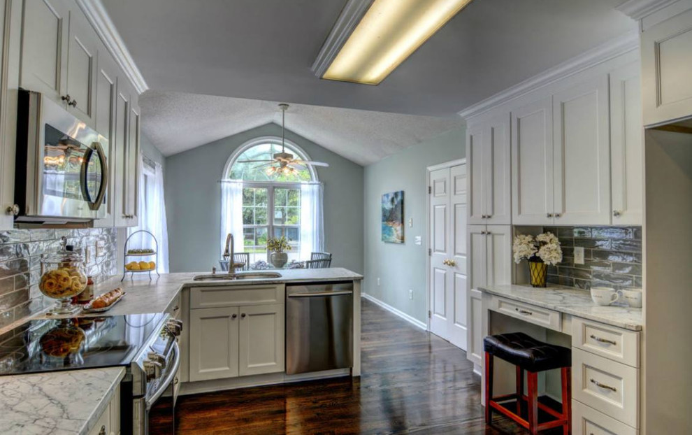 Eat-in kitchen - mid-sized transitional single-wall dark wood floor and brown floor eat-in kitchen idea in New York with a double-bowl sink, shaker cabinets, white cabinets, soapstone countertops, gray backsplash, subway tile backsplash, stainless steel appliances and a peninsula