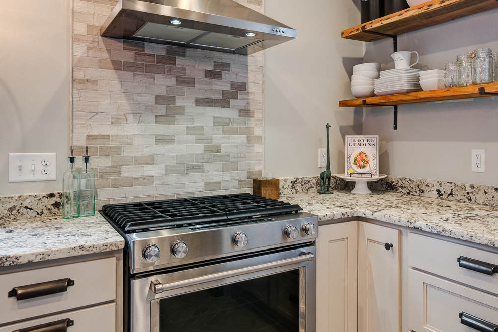 Eclectic ceramic tile kitchen photo in Columbus with a farmhouse sink, recessed-panel cabinets, gray cabinets, granite countertops and stainless steel appliances