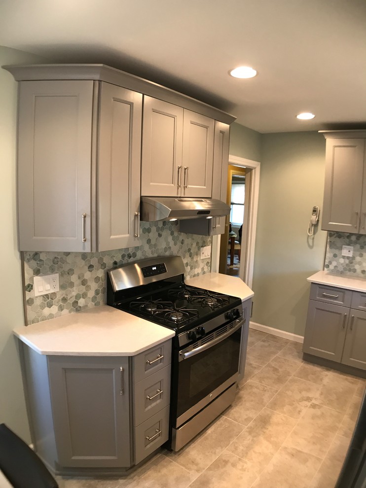 Enclosed kitchen - small contemporary galley porcelain tile and gray floor enclosed kitchen idea in New York with an undermount sink, shaker cabinets, gray cabinets, quartzite countertops, green backsplash, glass sheet backsplash, stainless steel appliances and no island