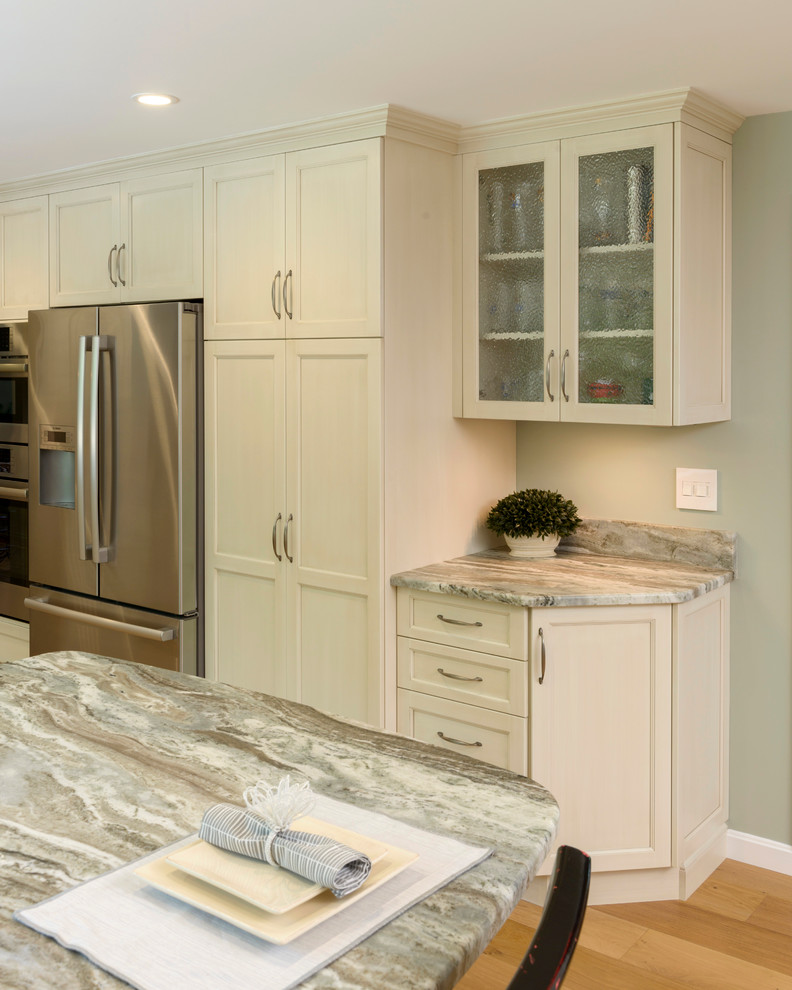 Eat-in kitchen - mid-sized transitional l-shaped light wood floor eat-in kitchen idea in Boston with a double-bowl sink, shaker cabinets, white cabinets, quartzite countertops, gray backsplash, mosaic tile backsplash, stainless steel appliances and a peninsula
