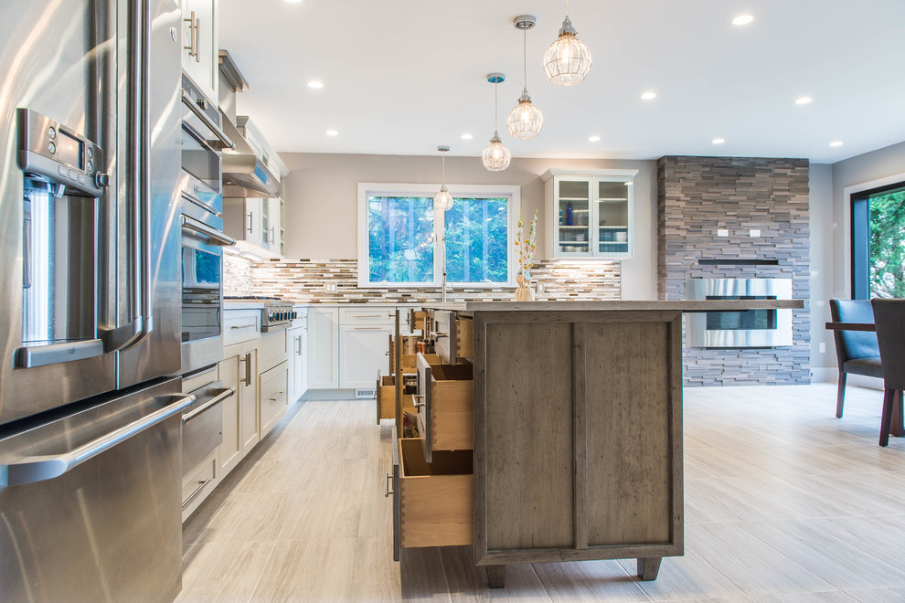 Inspiration for a transitional kitchen remodel in New York with an undermount sink, shaker cabinets, white cabinets and an island