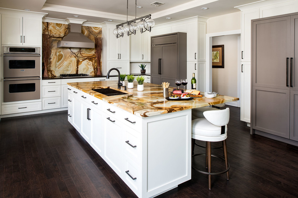 Eat-in kitchen - large modern l-shaped dark wood floor eat-in kitchen idea in New York with an island, an undermount sink, shaker cabinets, white cabinets, granite countertops, multicolored backsplash, stone slab backsplash and paneled appliances
