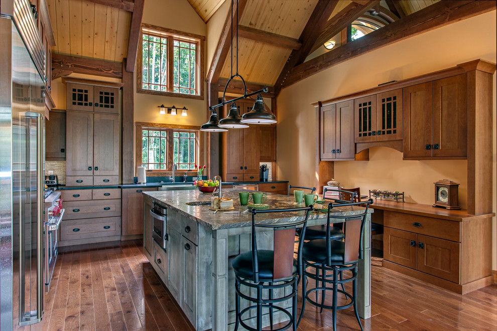 Design ideas for a rustic u-shaped kitchen in Nashville with a belfast sink, shaker cabinets, medium wood cabinets, stainless steel appliances, dark hardwood flooring and an island.