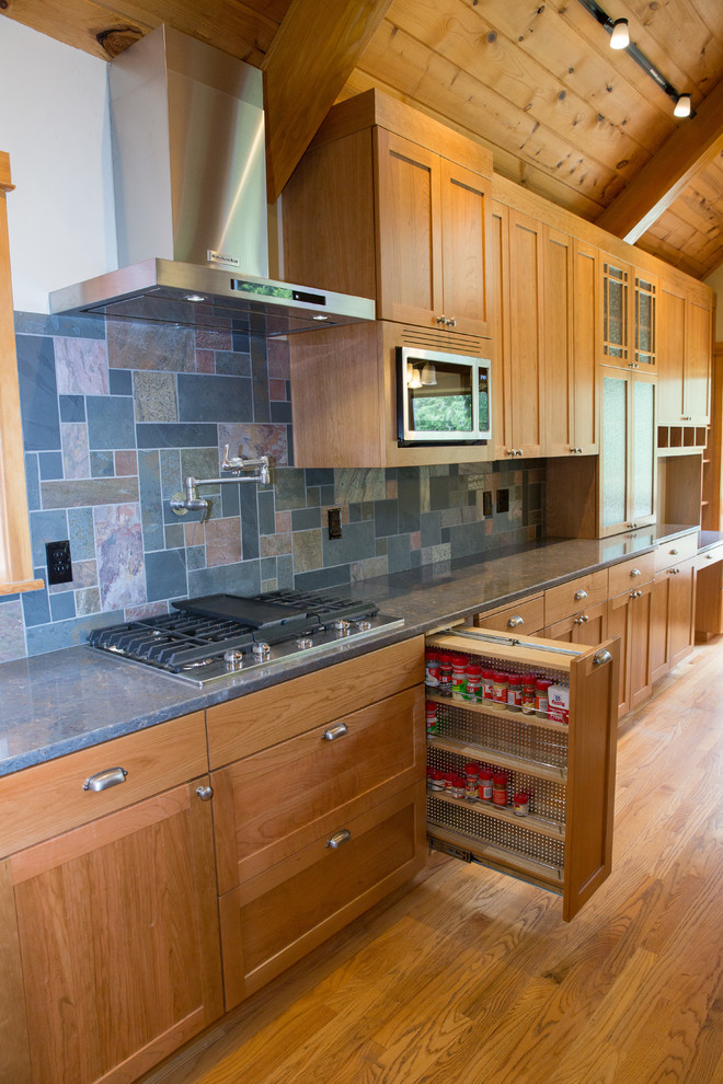 Inspiration for a large traditional l-shaped open plan kitchen in Other with a submerged sink, shaker cabinets, medium wood cabinets, engineered stone countertops, multi-coloured splashback, slate splashback, stainless steel appliances, medium hardwood flooring, an island and multi-coloured floors.
