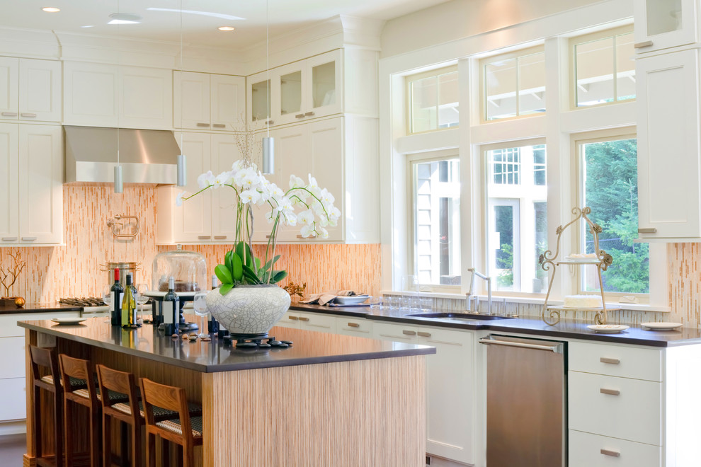 Inspiration for a mid-sized transitional l-shaped eat-in kitchen remodel in DC Metro with an undermount sink, shaker cabinets, white cabinets, multicolored backsplash, stainless steel appliances, an island, quartz countertops and glass tile backsplash