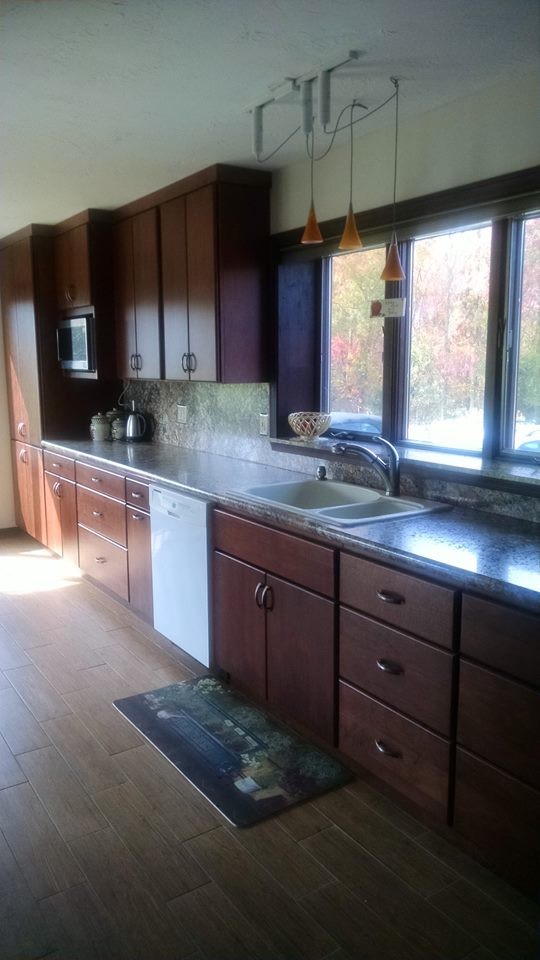 Photo of a large contemporary single-wall kitchen/diner in Providence with a double-bowl sink, dark wood cabinets, white appliances, flat-panel cabinets, laminate countertops, multi-coloured splashback, porcelain flooring and no island.