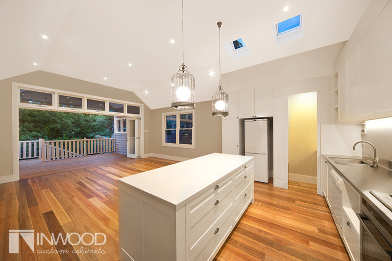 Trendy kitchen photo in Sydney with shaker cabinets and an island