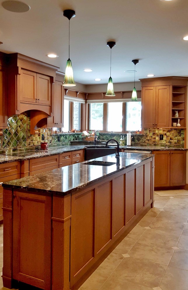 Example of a large classic u-shaped travertine floor eat-in kitchen design in Other with a farmhouse sink, recessed-panel cabinets, medium tone wood cabinets, quartzite countertops, green backsplash, ceramic backsplash, stainless steel appliances and an island