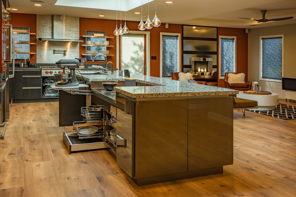 Photo of a large contemporary l-shaped open plan kitchen in San Francisco with a submerged sink, flat-panel cabinets, grey cabinets, recycled glass countertops, coloured appliances, an island and medium hardwood flooring.