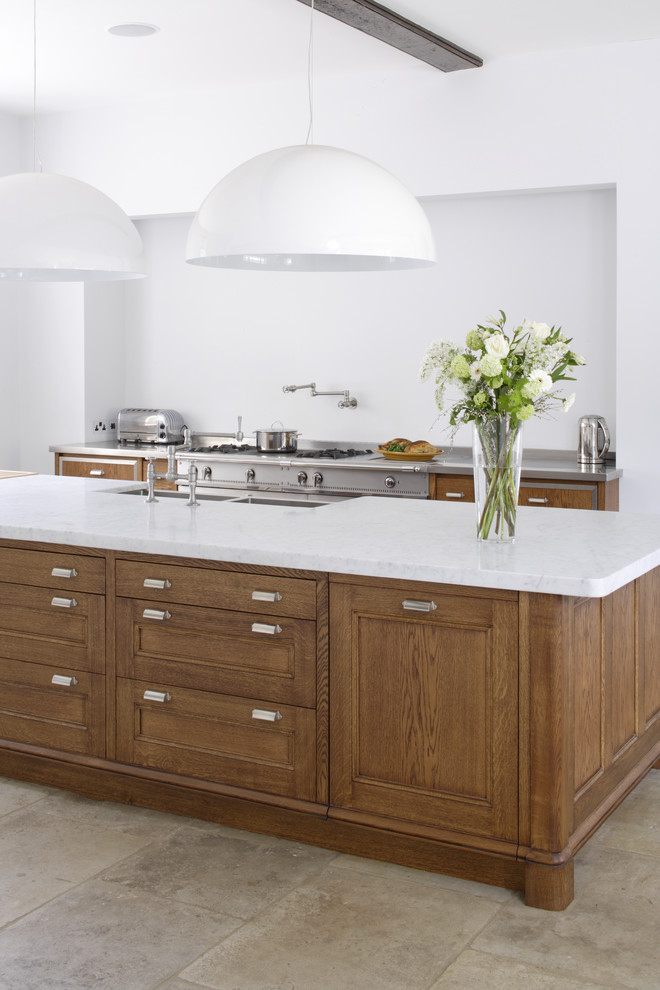 Inspiration for a large galley open plan kitchen in Gloucestershire with a double-bowl sink, recessed-panel cabinets, dark wood cabinets, marble worktops, limestone flooring and multiple islands.