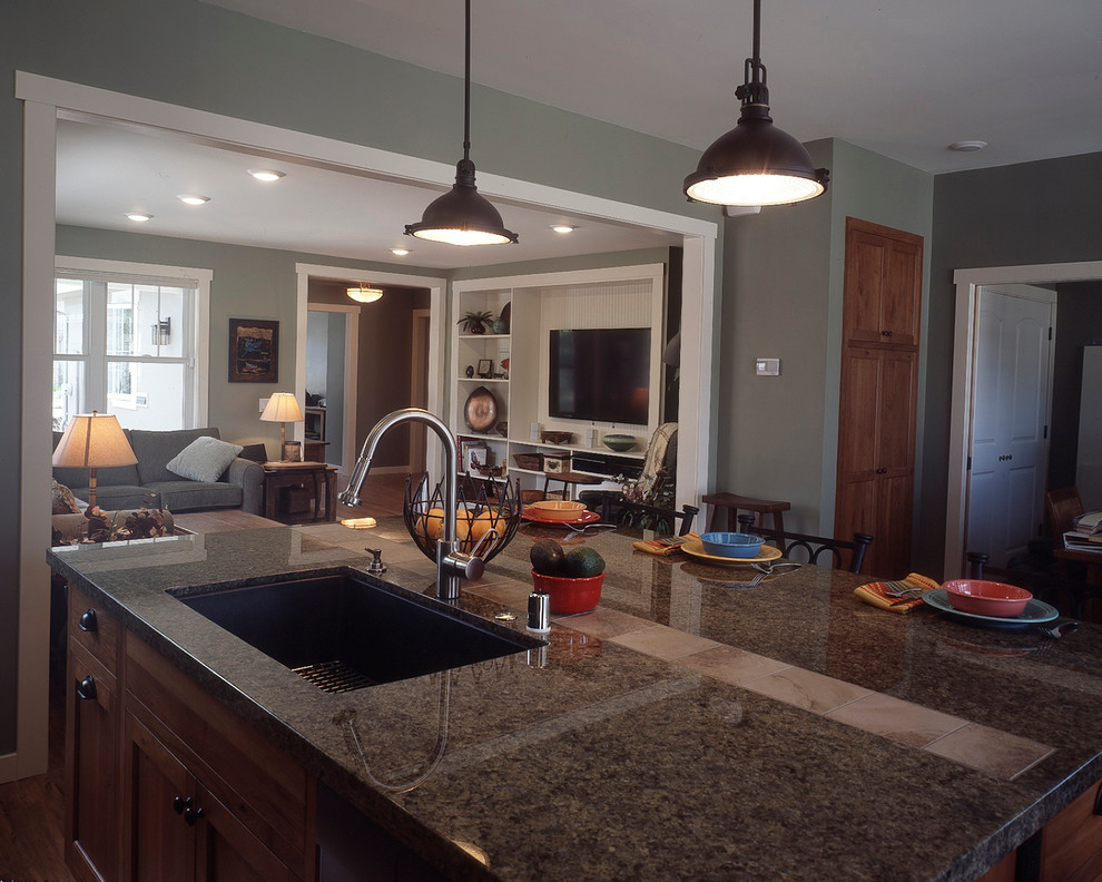 Kitchen island with cherry and granite countertop. Craftsman