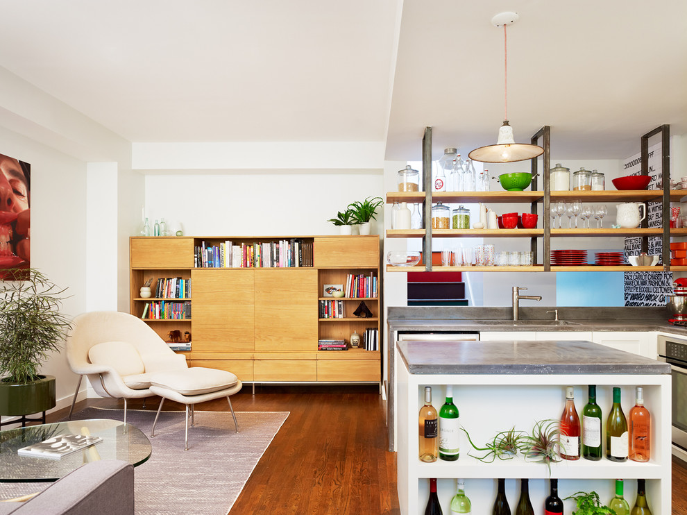 Example of a mid-sized trendy l-shaped dark wood floor open concept kitchen design in New York with open cabinets, concrete countertops, an undermount sink, white cabinets, stainless steel appliances and an island