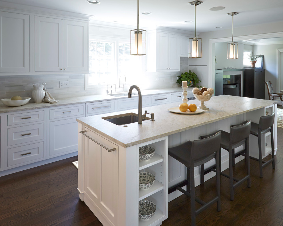 Inspiration for a large transitional u-shaped dark wood floor eat-in kitchen remodel in Chicago with an undermount sink, white cabinets, white backsplash, stainless steel appliances, an island, shaker cabinets, soapstone countertops and matchstick tile backsplash
