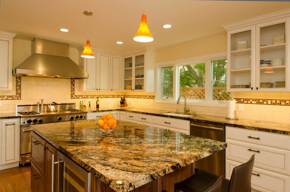 Inspiration for a mid-sized mediterranean u-shaped medium tone wood floor enclosed kitchen remodel in San Francisco with an undermount sink, beaded inset cabinets, white cabinets, marble countertops, white backsplash, subway tile backsplash, stainless steel appliances and an island
