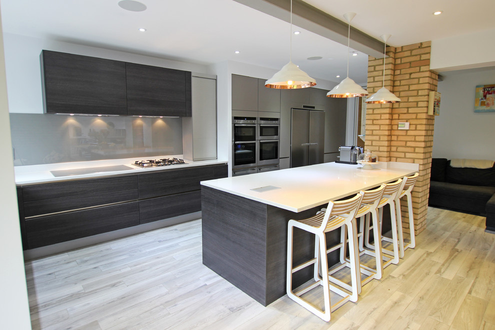 Design ideas for a large modern kitchen in London with dark wood cabinets and an island.