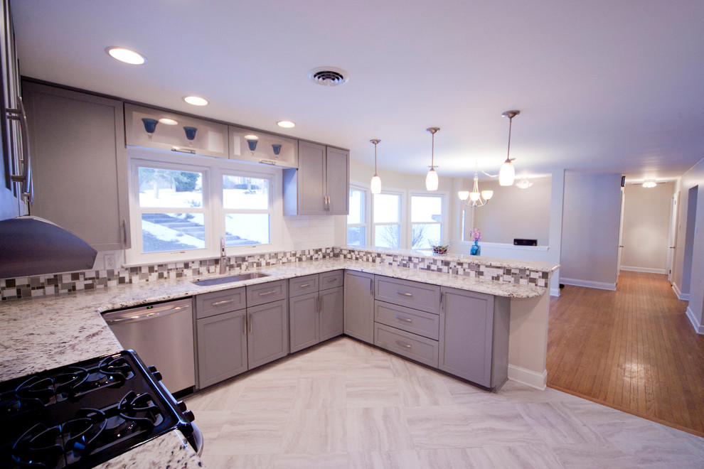 Inspiration for a mid-sized contemporary u-shaped linoleum floor open concept kitchen remodel in Philadelphia with a single-bowl sink, shaker cabinets, gray cabinets, granite countertops, white backsplash, ceramic backsplash, stainless steel appliances and a peninsula