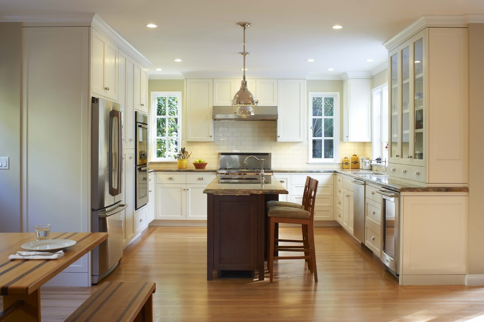Photo of a traditional kitchen in San Francisco with glass-front cabinets and stainless steel appliances.