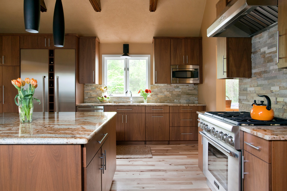 Example of a trendy kitchen design in Boston with stainless steel appliances and stone tile backsplash
